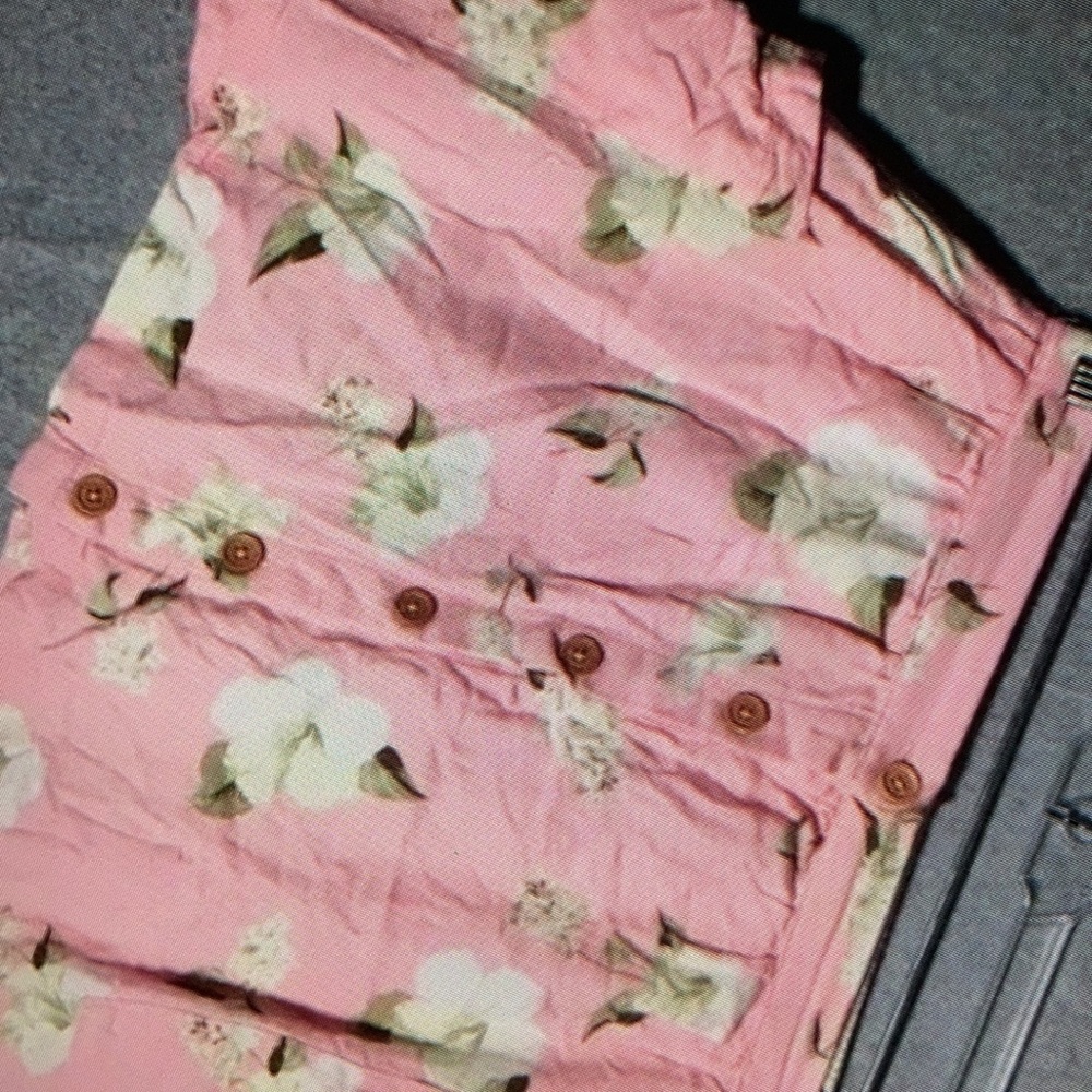 Simple design features vibrant floral shirt